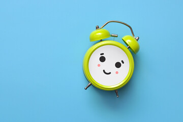 A smiling alarm clock. A symbol of a good morning and a happy time in life