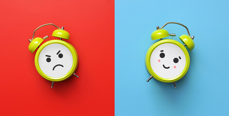 A smiling alarm clock and an angry alarm clock. A symbol of the choice between positive and...