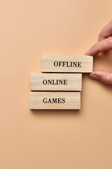 Wooden cubes with the inscription: online and offline games. Offline game selection symbol
