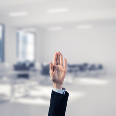 Choosing gesture of businessperson in elegant modern interior in sunshine light