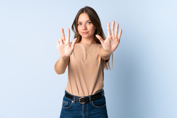 Young Lithuanian woman isolated on blue background counting eight with fingers