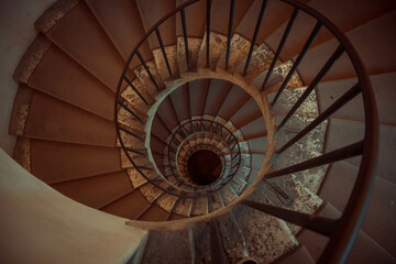 Spiral old stairs in a museum from above