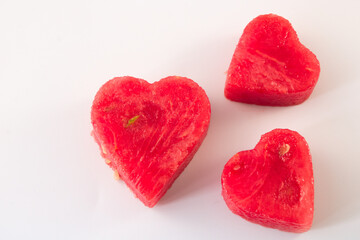 Naklejka na ściany i meble Three hearts cut out from watermelon isolated on white background, top view
