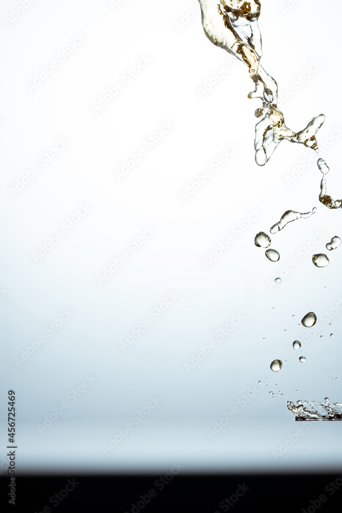 Aufkleber splash and droplets in the light background with a copy space