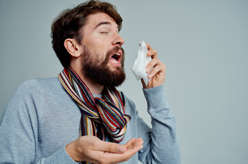 cold man wiping his nose with a handkerchief health problems isolated background