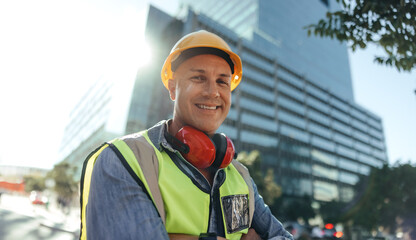 Cheerful workman smiling at the camera in the city