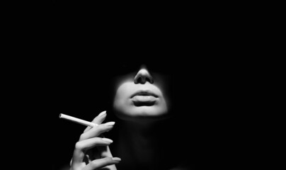 Beautiful woman with a cigarette in the dark © eugenepartyzan