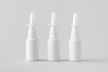 Nasal spray mockup. White plastic bottle with blank label.