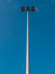 Reflector light pole on blue sky background