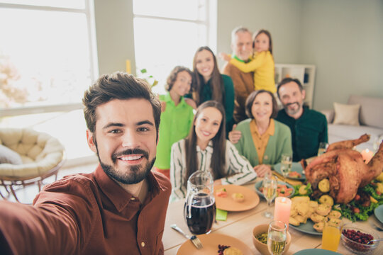 Photo of funny pretty family celebrating thanks giving day sitting table recording self video smiling indoors room home