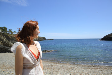 Fototapeta na wymiar Happy woman contemplating views on the beach on summer