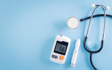 Healthcare and medical concept, Stethoscope and blood glucose meter sets on blue background, World Diabetes day, 14 November.