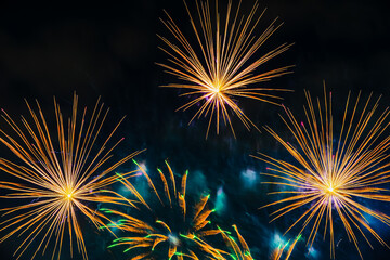 Colorful firework, multicolored glowing spheres and flickering stars in dark sky. Holiday background