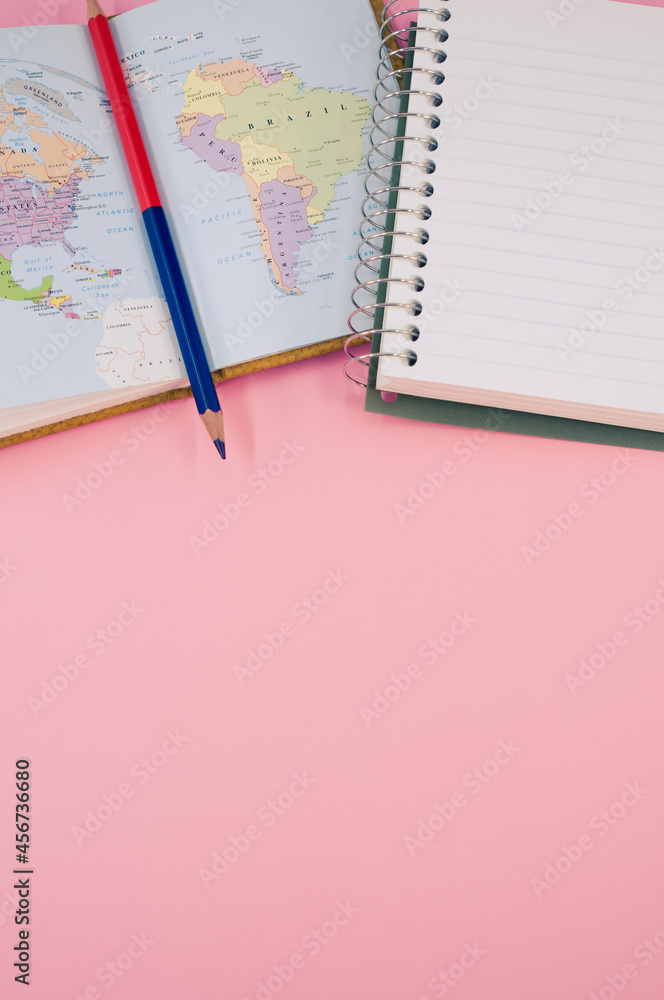 Aufkleber top view of a two-sided pen and a notebook on a pink background