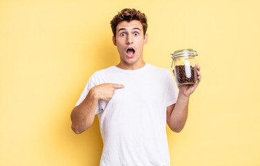 looking shocked and surprised with mouth wide open, pointing to self. coffee beans concept