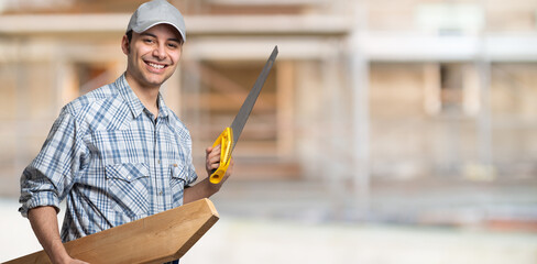 Portrait of a smiling carpenter in a construction site