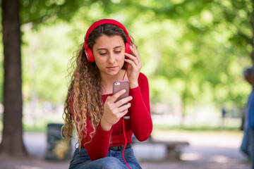 Fototapeta premium Teenager listening music in a park