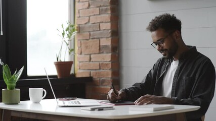 Distance studying, e-learning concept. Young man using laptop computer at home, study online. Student working in a room. Work or studying from home, business, creative occupation, meeting online