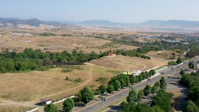 Famous  monument in  Artsakh, Armenia, Caucasus. Drone slowly move to famous statute grandfather and grandmother in Nagorno-Karabakh (Artsakh) region. Tourists near statue. T