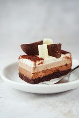 Slice of chocolate mousse cake on a plate, selective focus
