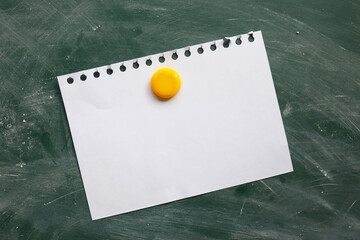 blank white sticker on a green chalk board attached with a round magnet, place to write