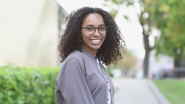 Young beautiful woman portrait, African american student girl in a city, Young businesswoman smiling outdoor, People, enjoy life, student lifestyle, city life, business concept