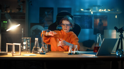 Smart Young Boy in Safety Goggles Mixes Colorful Chemicals in Beakers at Home. Teenager Conducting Educational Science Hobby Experiments, Doing Interesting Biology Homework in His Room.