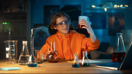 Smart Young Boy in Safety Goggles Mixes Colorful Chemicals in Beakers at Home. Teenager Conducting Educational Science Hobby Experiments, Doing Interesting Biology Homework in His Room.
