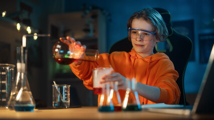 Smart Young Boy in Safety Goggles Mixes Colorful Chemicals in Beakers at Home. Teenager Conducting Educational Science Hobby Experiments, Doing Interesting Biology Homework in His Room.