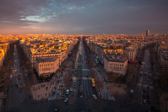 Cityscape with roads and buildings under sunset sky