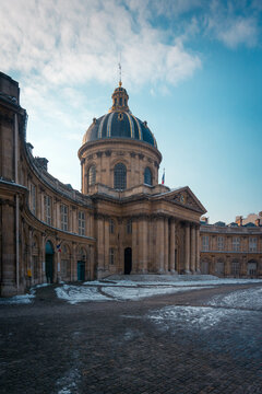 Old college facade with cupola in winter city