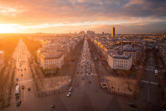 Cityscape with roads and buildings under sunset sky