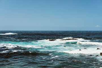 Rough sea landscape with rocks on the shore