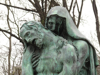 Bust detail of a bronze sculpture of Virgin Maria and Jesus Christ in the Pere Lachaise cemetery....