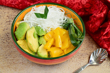 Es Teler, es campur, is an Indonesian fruit cocktail. Avocado, young coconut meat, jackfruit and simple syrup, served with coconut milk or sweetened condensed milk.