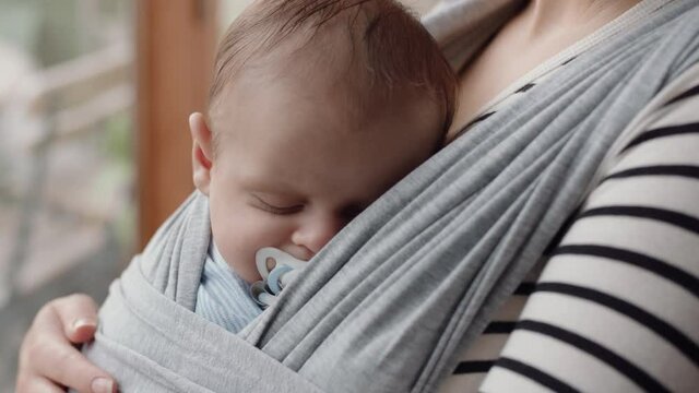 Young Mother Holding Sleeping Baby Looking Out Window Contemplating Future Of Child Planning Ahead Embracing Motherhood Responsibility