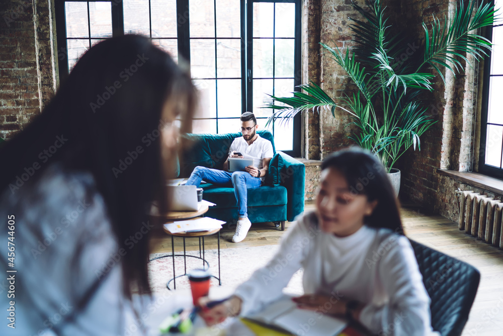 Aufkleber millennial male blogger connecting to 4g wireless internet for browsing web content while blurred fe