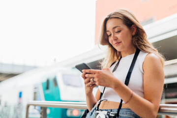 Young caucasian woman outdoor smiling using smartphone shopping online browsing web