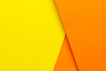 abstract background concept with geometric shapes of three layers of orange paper and yellow paper background