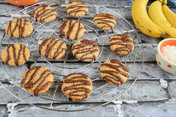 Banana coconut cookies drizzled with melted chocolate