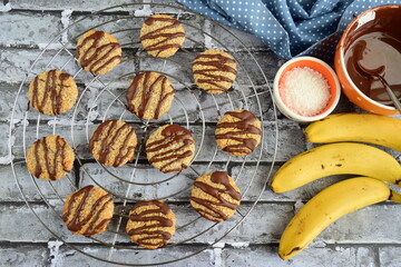 Banana coconut cookies drizzled with melted chocolate