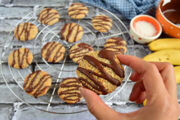 Banana coconut cookies drizzled with melted chocolate. Selective focus