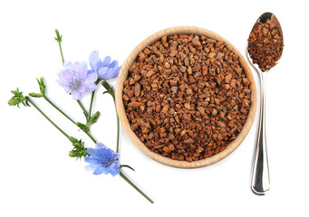 Chicory granules and flowers on white background, top view