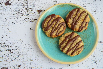 Banana coconut cookies drizzled with melted chocolate. Top view