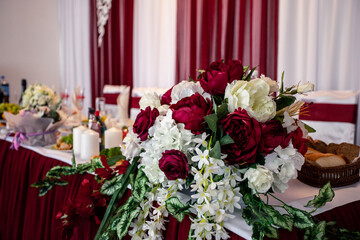 beautiful bouquet of red roses on the wedding table.