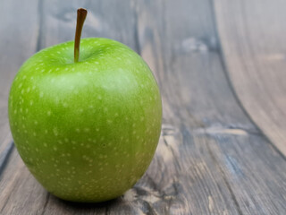 The Natural Green apple on a wooden background close-up.