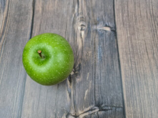 The Natural Green apple on a wooden background close-up.
