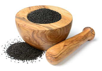 kalonji seeds in the wooden mortar, isolated on the white background