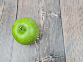 The Natural Green apple on a wooden background close-up.