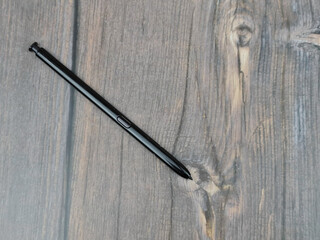 The Black stylus from a mobile device. Digital stylus close-up.